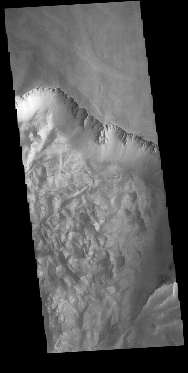 Today's VIS image shows part of the northern cliff face of Melas Chasma and the large landslide deposits at the base of the cliff face. The landslide deposits are called Ophir Labes. The descriptor term labes means landslide.  Orbit Number: 74275 Latitude: -9.66666 Longitude: 290.547 Instrument: VIS Captured: 2018-09-12 01:22  https://photojournal.jpl.nasa.gov/catalog/PIA22797