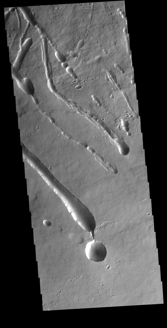 The linear features in this VIS image are located on part of the large flow feature on the southern flank of Ascraeus Mons. The features most likely formed by collapse of the surface into voids created by tube fed lava flows. Orbit Number: 74376 Latitude: 8.57379 Longitude: 253.317 Instrument: VIS Captured: 2018-09-20 09:08 https://photojournal.jpl.nasa.gov/catalog/PIA22843