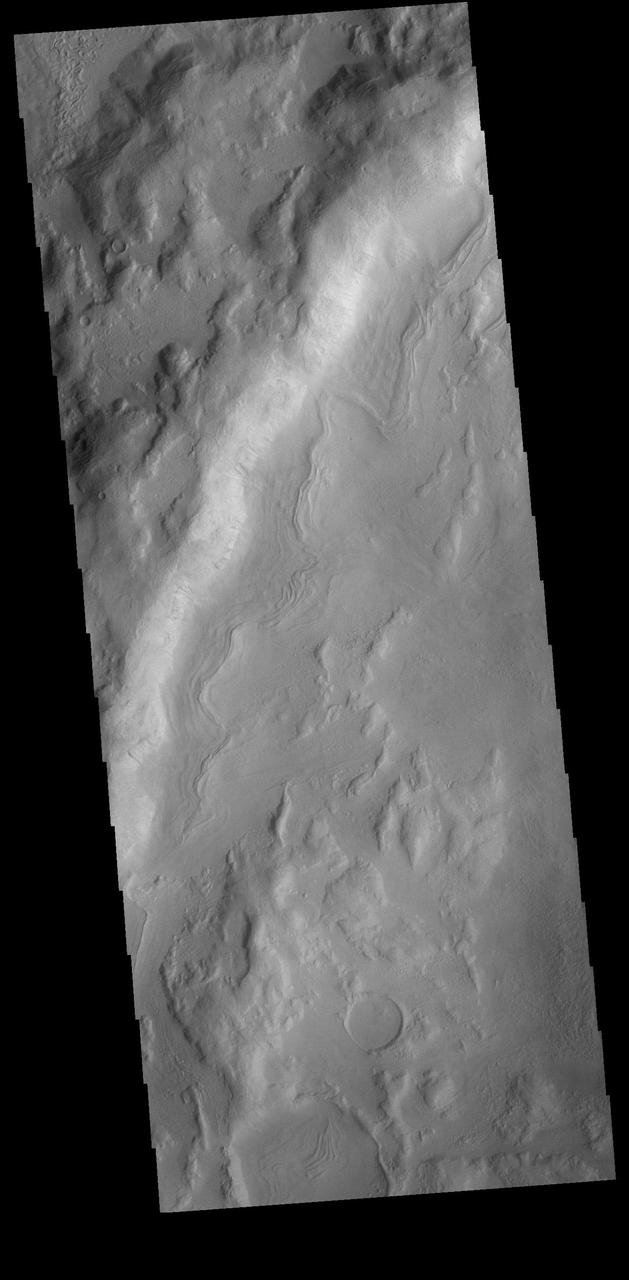 This VIS image is located in an unnamed crater in Noachis Terra. The sinuous feature near the bottom of the crater rim appears to have been caused by down slope movement of materials. The sinuous nature may have been created by inclusion of a volatile material such as ice.  Orbit Number: 74447 Latitude: -39.937 Longitude: 11.1296 Instrument: VIS Captured: 2018-09-26 05:13  https://photojournal.jpl.nasa.gov/catalog/PIA22844