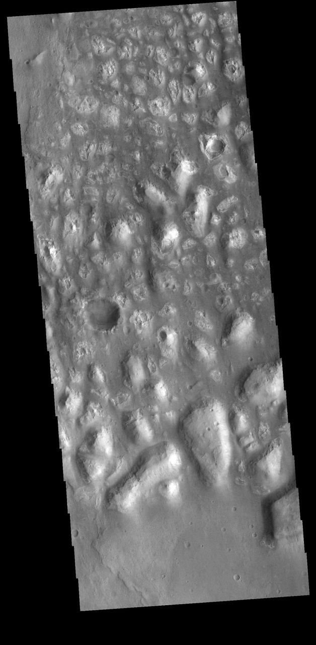 This image is located in Terra Cimmeria. The bright, irregular features are hills. This part of Terra Cimmeria is made up mostly by flat lying plains, with no other hills in the nearby vicinity. Orbit Number: 74529 Latitude: -37.2521 Longitude: 164.216 Instrument: VIS Captured: 2018-10-02 23:20 https://photojournal.jpl.nasa.gov/catalog/PIA22853