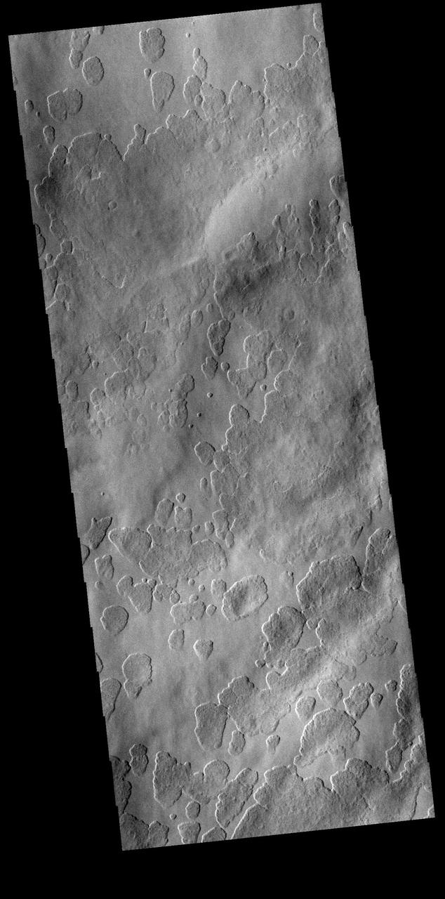 Amphitrites Patera is an old volcanic complex located south of Hellas Planitia. The surface in this VIS image has a unusual texture, one seen more commonly on the nearby south polar ice. The surface appears to be eroding in a fashion that creates small circular features which grow and coalesce into larger circles.  Orbit Number: 74545 Latitude: -57.6389 Longitude: 66.7121 Instrument: VIS Captured: 2018-10-04 06:51  https://photojournal.jpl.nasa.gov/catalog/PIA22854