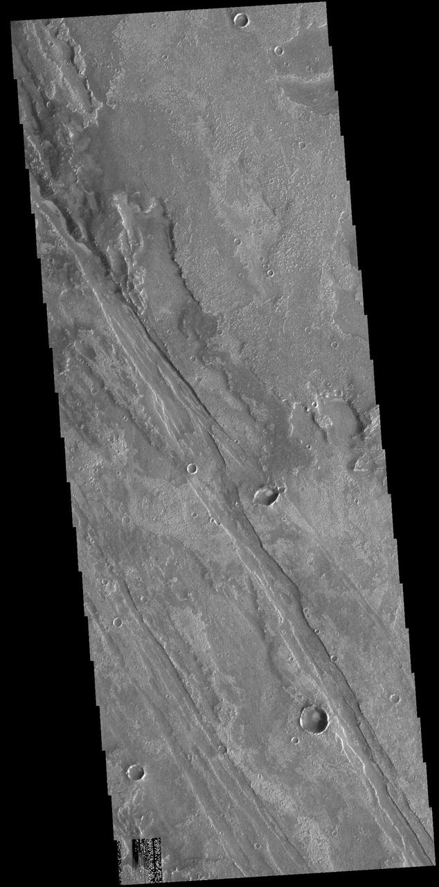 Today's VIS image shows part of Solis Planum. Both volcanic and tectonic forces created the features in this image. The linear features that run diagonally across the image are fault features called graben. The rough surfaced regions are volcanic flows. Orbit Number: 74613 Latitude: -20.2864 Longitude: 257.634 Instrument: VIS Captured: 2018-10-09 21:29 https://photojournal.jpl.nasa.gov/catalog/PIA22860