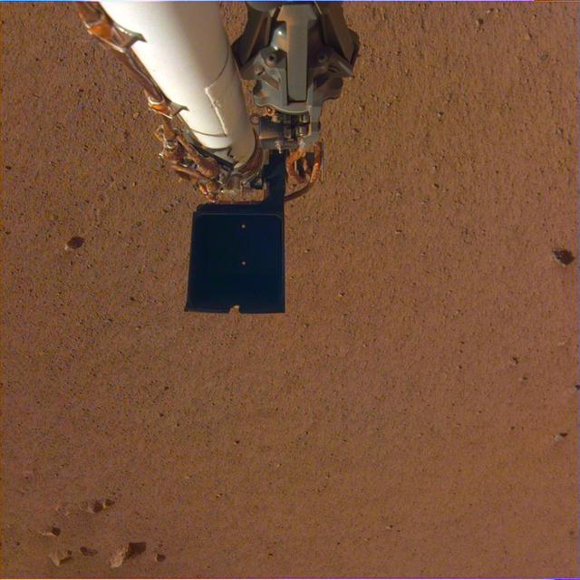 NASA's InSight spacecraft took a color-calibrated image of its robotic arm using its Instrument Deployment Camera on Dec. 4, 2018 (Sol 8). The camera still has a transparent dust cover on it, but the robotic arm can clearly be seen above the Martian soil. There is a dark scoop at the end of the arm. Above the scoop is the stowed grapple, the claw that InSight will use to grab and move its instruments from its deck onto the planet's surface. InSight will be the first Mars mission to use a robotic arm to grasp objects and deploy them onto the surface of another planet. https://photojournal.jpl.nasa.gov/catalog/PIA22872