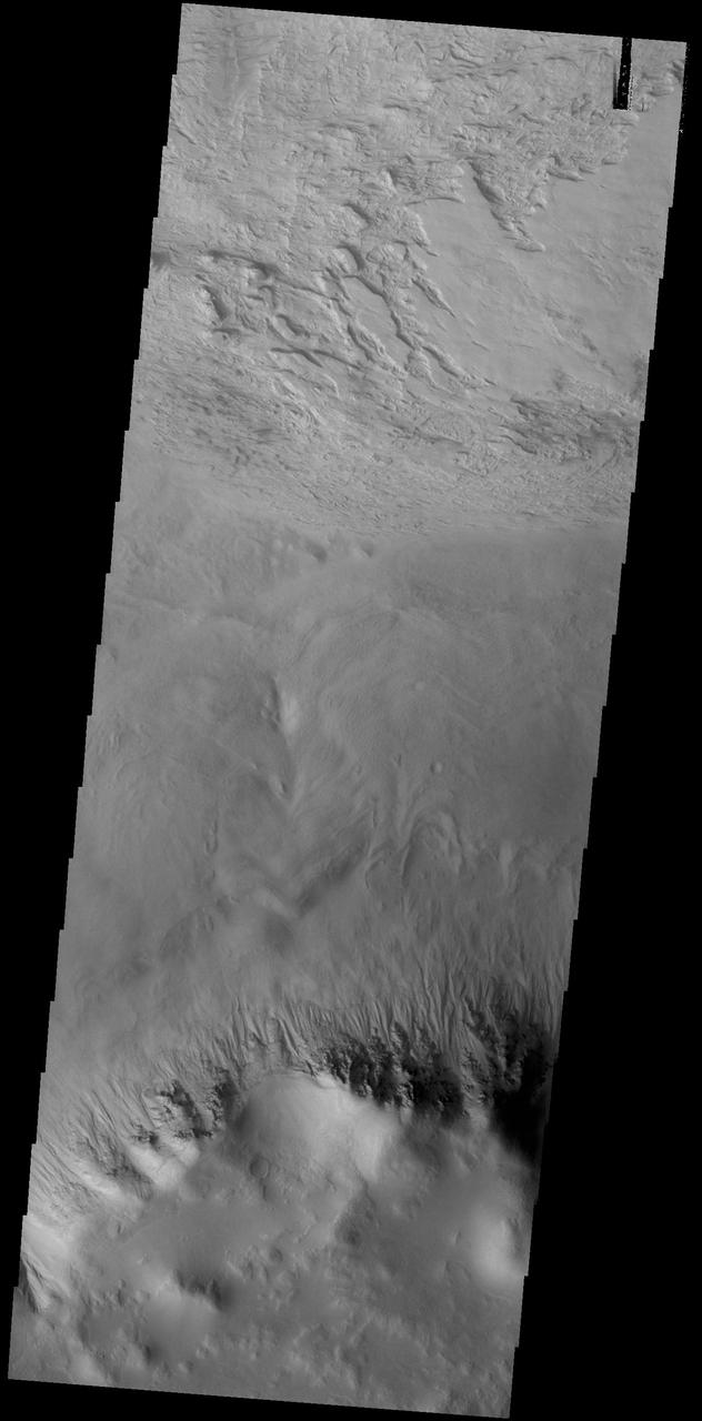 This VIS image shows a small portion of the floor of Galle Crater. This large crater is located on the eastern side of Argyre Planitia. The floor of Galle Crater contains many different features, including fluvial, glacial and aeolian derived products. The steep crater rim is toward the bottom of the image. The incised, flat laying materials at the top of the image are probably eroded layered deposits.  Orbit Number: 74804 Latitude: -52.1339 Longitude: 329.267 Instrument: VIS Captured: 2018-10-25 14:28  https://photojournal.jpl.nasa.gov/catalog/PIA22884