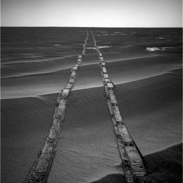 In this navigation camera raw image, NASA's Opportunity Rover looks back over its own tracks on Aug. 4, 2010. https://photojournal.jpl.nasa.gov/catalog/PIA22928