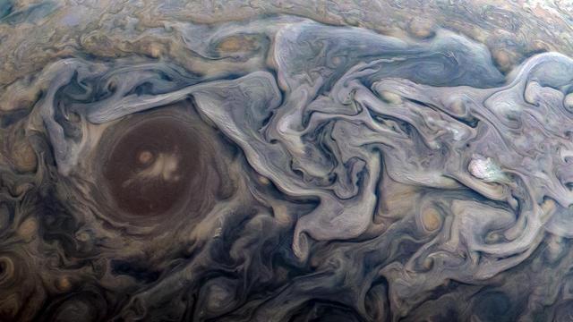 Dramatic atmospheric features in Jupiter's northern hemisphere are captured in this view from NASA's Juno spacecraft. The new perspective shows swirling clouds that surround a circular feature within a jet stream region called "Jet N6." This color-enhanced image was taken at 9:20 a.m. PST (12:20 p.m. EST) on Feb. 12, 2019, as the spacecraft performed its 18th close flyby of the gas giant planet. At the time, Juno was about 8,000 miles (13,000 kilometers) from the planet's cloud tops, above a latitude of approximately 55 degrees north. https://photojournal.jpl.nasa.gov/catalog/PIA22944. Enhanced image by Kevin M. Gill (CC-BY) based on images provided courtesy of NASA/JPL-Caltech/SwRI/MSSS