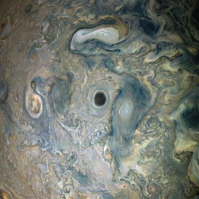NASA's Juno spacecraft captured this view of an area within a Jovian jet stream showing a vortex that has an intensely dark center. Nearby, other features display bright, high altitude clouds that have puffed up into the sunlight. The color-enhanced image was taken at 12:55 a.m. PDT (3:55 a.m. EDT) on May 29, 2019, as the spacecraft performed its 20th science flyby of Jupiter. At the time, Juno was about 9,200 miles (14,800 kilometers) from the planet's cloud tops, above approximately 52 degrees north latitude. Citizen scientists Gerald Eichstädt and Seán Doran created this image using data from the spacecraft's JunoCam imager. https://photojournal.jpl.nasa.gov/catalog/PIA22948