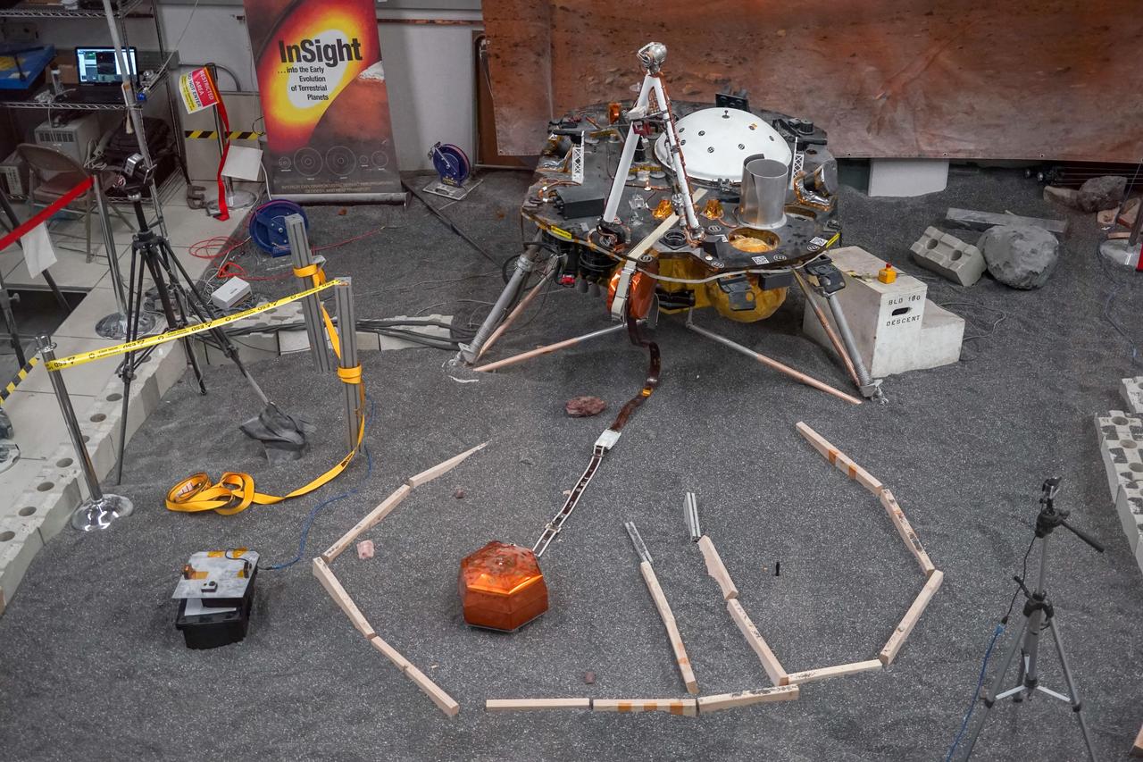ForeSight, a fully functional, full-size model of NASA's InSight lander, sits in a lab space that has been sculpted to match terrain in front of the real lander on Mars. This work was done at NASA's Jet Propulsion Laboratory in Pasadena, California.  https://photojournal.jpl.nasa.gov/catalog/PIA22953