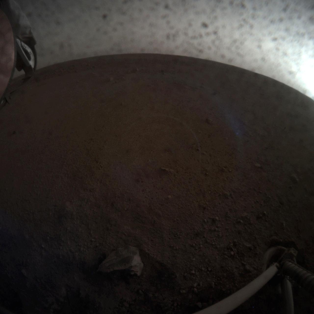 A fish-eye view of NASA's InSight lander deploying its first instrument onto the surface of Mars. InSight's robotic arm placed the seismometer on Dec. 19, 2018, around the time of dusk on Mars. These images were taken by the Instrument Context Camera (ICC), a fish-eye camera under the spacecraft's deck.  Animation available at https://photojournal.jpl.nasa.gov/catalog/PIA22978
