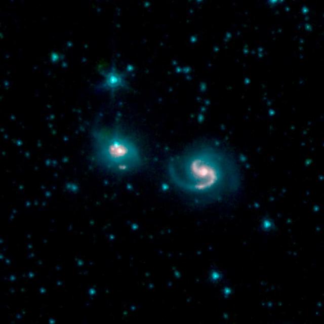 This image shows the merger of two galaxies, known as NGC 6786 (right) and UGC 11415 (left), also collectively called VII Zw 96. It is composed of images from three Spitzer Infrared Array Camera (IRAC) channels: IRAC channel 1 in blue, IRAC channel 2 in green and IRAC channel 3 in red.  https://photojournal.jpl.nasa.gov/catalog/PIA23007