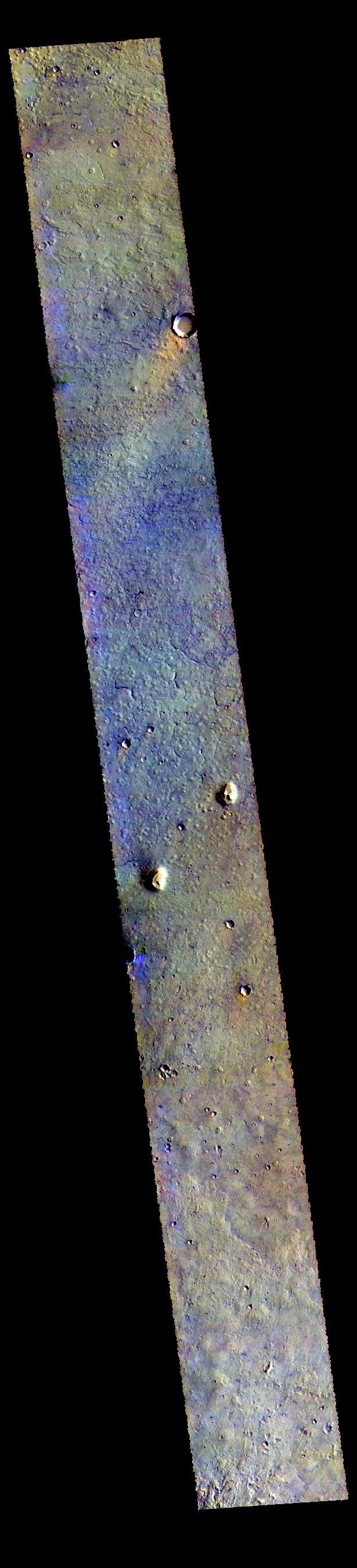 Today's VIS image is located in the plains between Chryse and Acidalia Planitias. Dark blue tones in this false color combination are usually created by basaltic sands. There appears to be surface sands in the middle of the image. The "orange" tail behind the crater towards the top of the image is created by wind action. Wind will both erode and deposit fine materials. The wind tail is the downward side of the crater. These features are termed windstreaks, and they help to understand the direction of wind. Both the windstreak and the surface sands indicate a dusty/sandy region confined to the central part of this image.  The THEMIS VIS camera contains 5 filters. The data from different filters can be combined in multiple ways to create a false color image. These false color images may reveal subtle variations of the surface not easily identified in a single band image.  Orbit Number: 62487 Latitude: 35.5378 Longitude: 328.516 Instrument: VIS Captured: 2016-01-14 23:06  https://photojournal.jpl.nasa.gov/catalog/PIA23111
