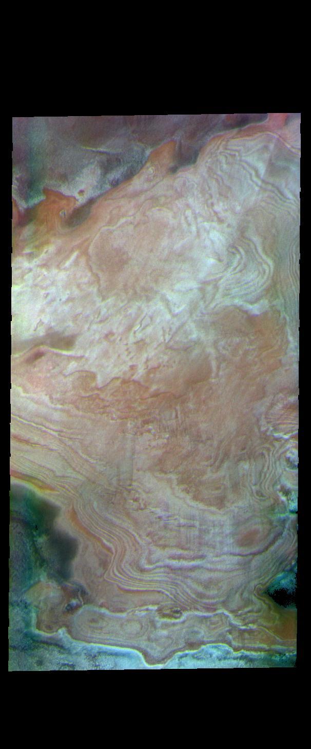 The polar caps of Mars were deposited over millions of years. Seasonal depositions of ice and dust have created layer upon layer of material. In this false color image the white and orange layered features are the polar cap. The greenish and purplish regions are ice free surfaces.  The THEMIS VIS camera contains 5 filters. The data from different filters can be combined in multiple ways to create a false color image. These false color images may reveal subtle variations of the surface not easily identified in a single band image.  Orbit Number: 62954 Latitude: 78.1067 Longitude: 3.4796 Instrument: VIS Captured: 2016-02-22 10:34  https://photojournal.jpl.nasa.gov/catalog/PIA23115