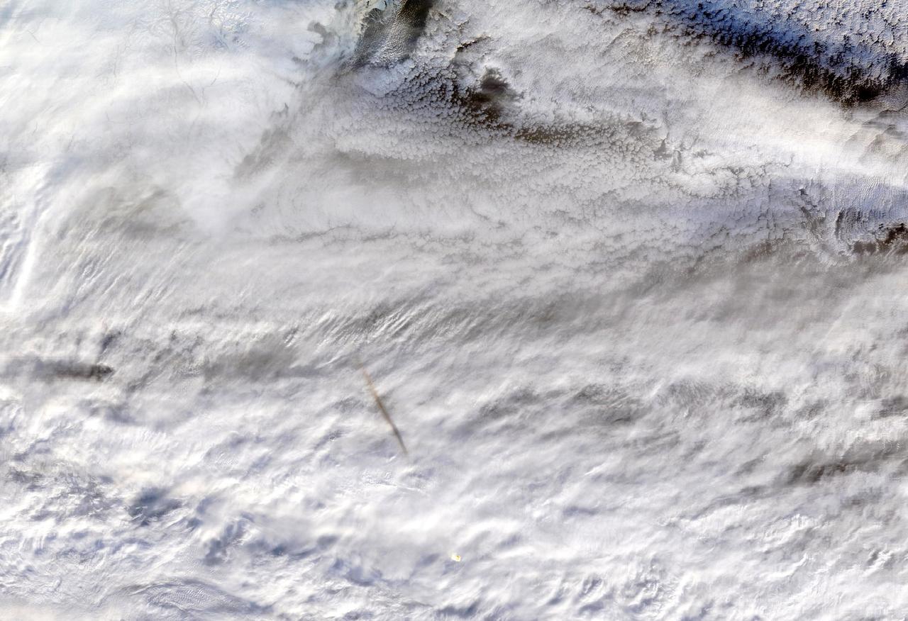 NASA's Moderate Resolution Imaging SpectroRadiometer (MODIS) instrument, aboard the Terra satellite, captured this true-color image showing the remnants of a meteor's passage, seen as a dark shadow cast on thick, white clouds on Dec. 18, 2018. MODIS captured the image at 23:50 Coordinated Universal Time (UTC).  https://photojournal.jpl.nasa.gov/catalog/PIA23141