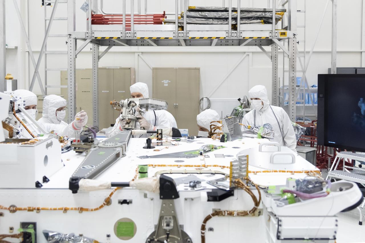Mars 2020 engineers and technicians prepare the high-gain antenna for installation on the rover's equipment deck. The antenna is articulated so it can point itself directly at Earth to uplink or downlink data.  The image was taken on April 19, 2019, in the Spacecraft Assembly Facility's High Bay 1 clean room at NASA's Jet Propulsion Laboratory, in Pasadena, California.  https://photojournal.jpl.nasa.gov/catalog/PIA23193