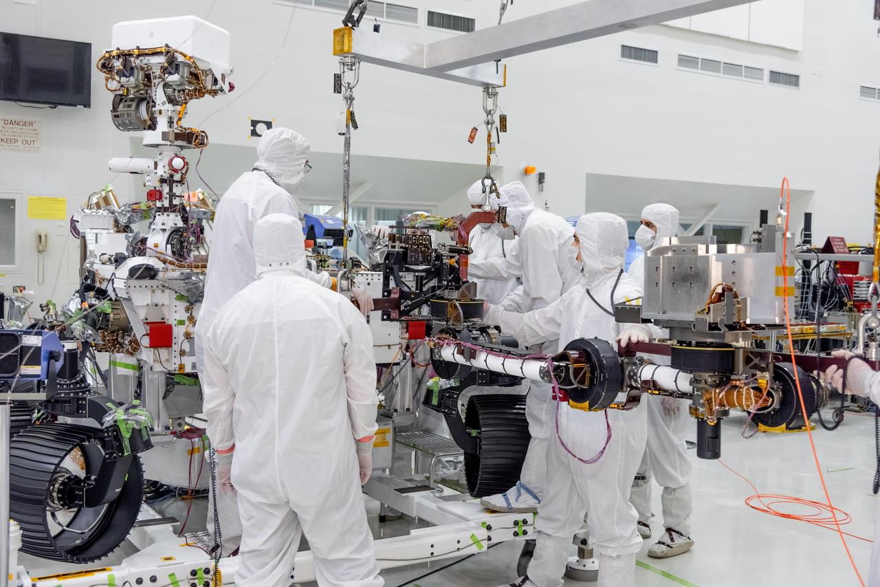 On June 21, 2019, engineers at NASA's Jet Propulsion Laboratory install the main robotic arm on the Mars 2020 rover. Measuring 7 feet (2.1 meters) long, the arm will allow the rover to work as a human geologist would: by holding and using science tools with its turret.  https://photojournal.jpl.nasa.gov/catalog/PIA23227