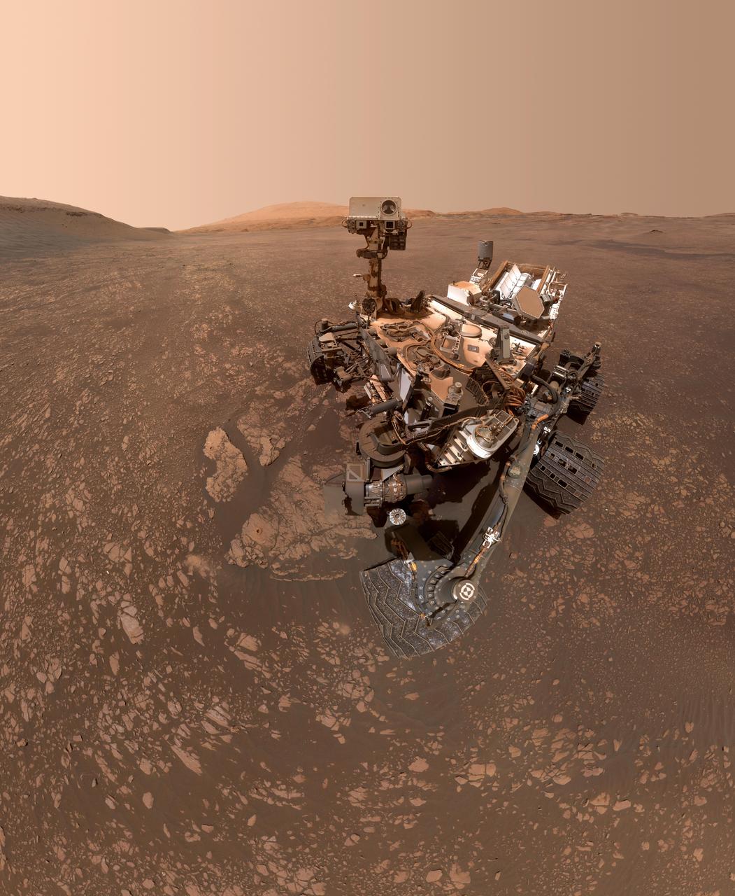 NASA's Curiosity Mars rover took this selfie on May 12, 2019 (the 2,405th Martian day, or sol, of the mission). To the lower-left of the rover are its two recent drill holes, at targets called "Aberlady" and "Kilmarie."  These are Curiosity's 20th and 21st drill sites.  The selfie is composed of 57 individual images taken by the rover's Mars Hand Lens Imager (MAHLI), a camera on the end of the rover's robotic arm. The images are stitched together into a panorama, and the robotic arm is digitally removed.  https://photojournal.jpl.nasa.gov/catalog/PIA23240