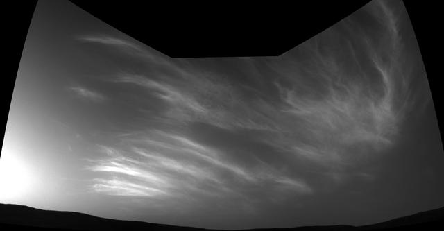 NASA's Curiosity Mars rover imaged these drifting clouds on May 17, 2019, the 2,410th Martian day, or sol, of the mission, using its black-and-white Navigation Cameras (Navcams). These are likely water-ice clouds about 19 miles (31 kilometers) above the surface. They are also "noctilucent" clouds, meaning they are so high that they are still illuminated by the Sun, even when it's night at Mars' surface. Scientists can watch when light leaves the clouds and use this information to infer their altitude. Movie available at https://photojournal.jpl.nasa.gov/catalog/PIA23243