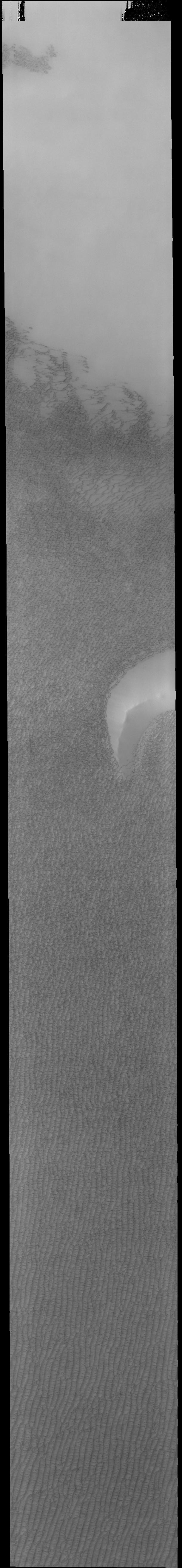 Today's VIS image is located over Olympia Undae, the largest of several dune fields that surround the north polar cap. The dunes look like salt and pepper against a bright background. The spring arrival of the sun has begun the defrosting process, and most of the dunes are still covered in frost. As the season progresses the dunes will appear darker and darker as the dark sand is revealed from under the bright frost cover.  Orbit Number: 77196 Latitude: 79.7649 Longitude: 219.771 Instrument: VIS Captured: 2019-05-10 15:23  https://photojournal.jpl.nasa.gov/catalog/PIA23295
