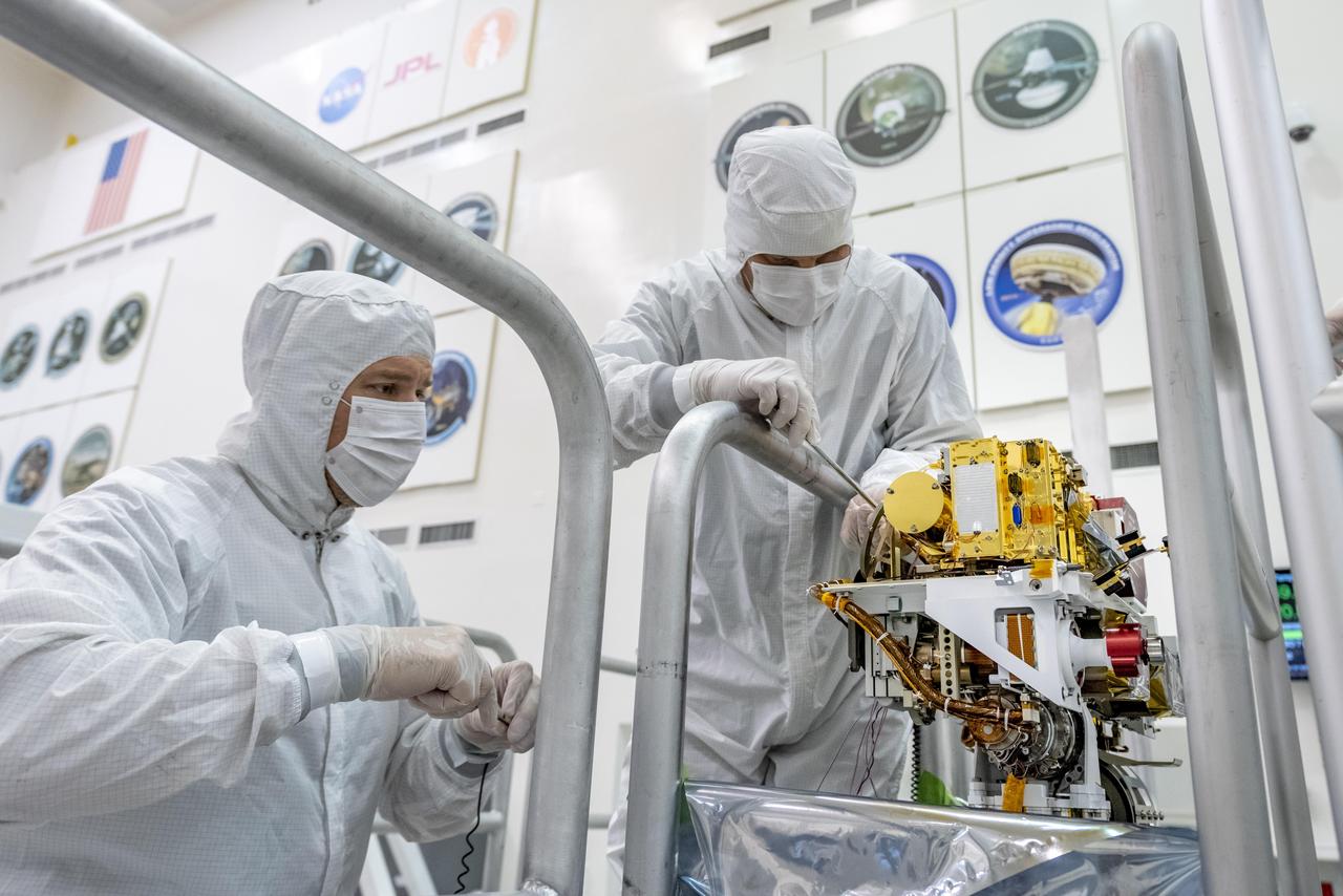 Engineers install the SuperCam instrument on Mars 2020's rover. This image was taken on June 25, 2019, in the Spacecraft Assembly Facility at NASA's Jet Propulsion Laboratory, Pasadena, California.  https://photojournal.jpl.nasa.gov/catalog/PIA23307