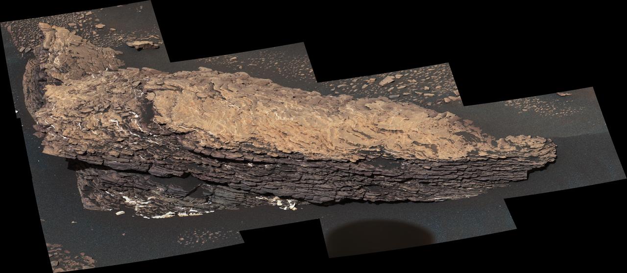 This mosaic of images shows a boulder-sized rock called "Strathdon," which is made up of many complex layers. NASA's Curiosity Mars rover took these images using its Mast Camera, or Mastcam, on July 9, 2019, the 2,461st Martian sol, or day, of the mission.  The color in the image has been adjusted to approximate white balancing to resemble how the rocks and sand would appear under daytime lighting conditions on Earth.  https://photojournal.jpl.nasa.gov/catalog/PIA23348