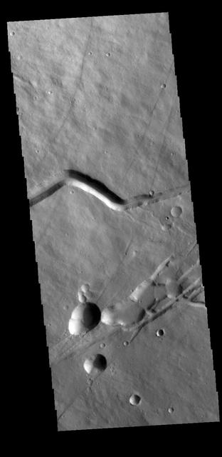 Today's VIS image shows a portion of the flank of Albor Tholus, a volcano found in the Elysium volcanic complex. The caldera of the volcano is very deep compared to it's height. The top elevation of Albor Tholus is approximately 4.5km, the deepest part of the caldera measures 3km below this [an elevation of only 1.5km].  Orbit Number: 77798 Latitude: 18.4758 Longitude: 151.507 Instrument: VIS Captured: 2019-06-29 04:49  https://photojournal.jpl.nasa.gov/catalog/PIA23382