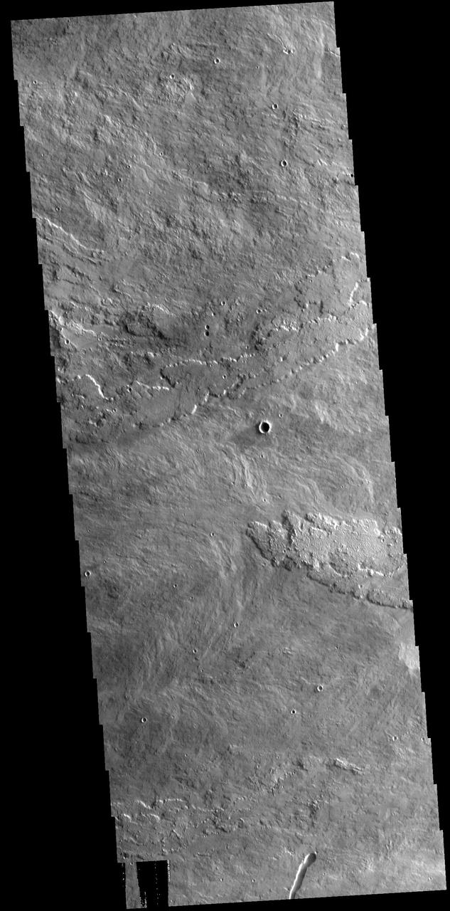 Arsia Mons is the southermost of the large aligned Tharsis volcanoes. Flows originating at Arsia Mons cover a vast region. The flows in this VIS image are part of the SW flow apron of Arsia Mons. The Tharsis trend runs NE/SW thru the centers of the volcanoes creating regions of greater tectonic and volcanic activities along this trend. Orbit Number: 77895 Latitude: -11.9896 Longitude: 236.892 Instrument: VIS Captured: 2019-07-07 04:22 https://photojournal.jpl.nasa.gov/catalog/PIA23395