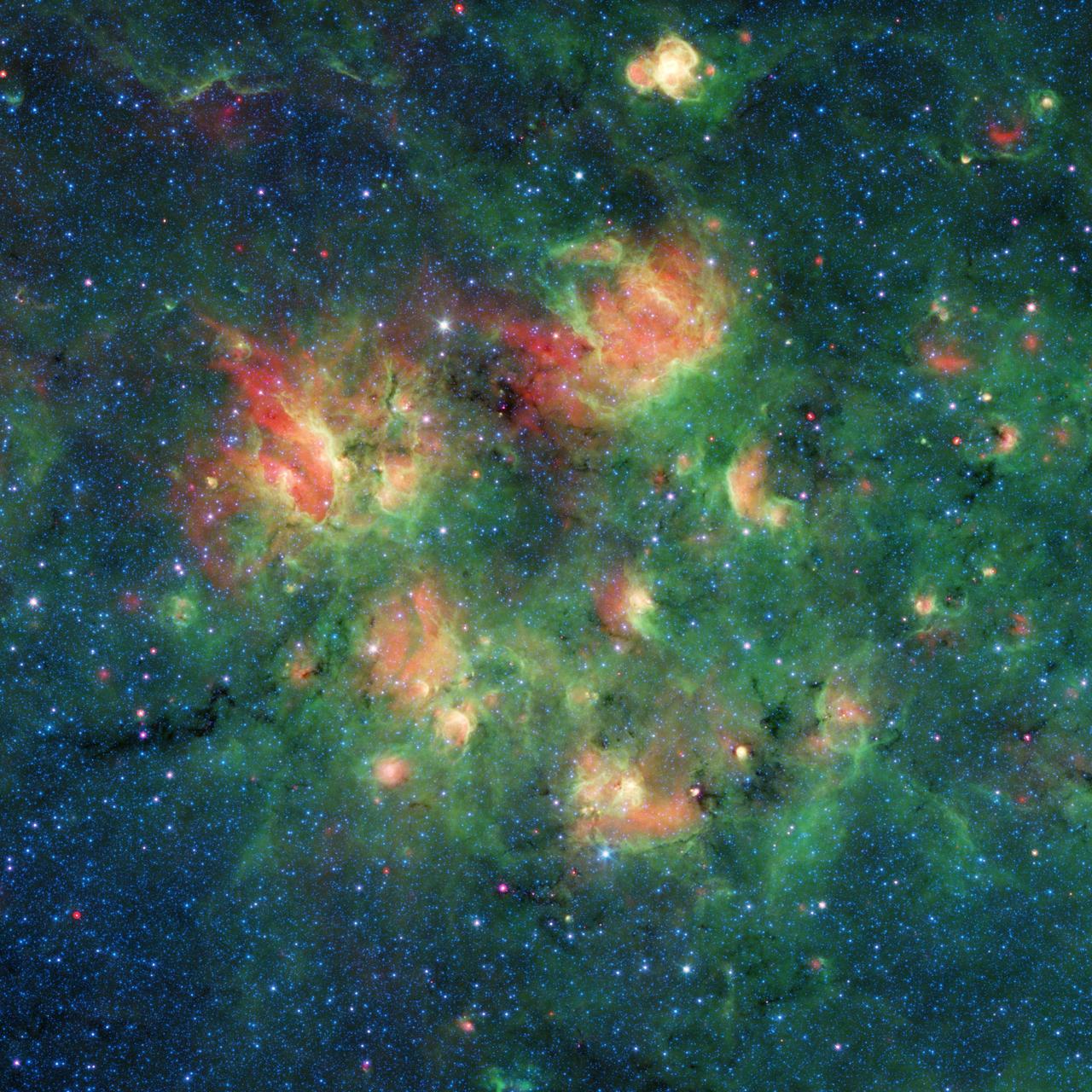This infrared image from NASA's Spitzer Space Telescope shows a cloud of gas and dust full of bubbles, which are inflated by wind and radiation from massive young stars. Each bubble is filled with hundreds to thousands of stars, which form from dense clouds of gas and dust. The bubbles are estimated to be 10 to 30 light-years across, based on what astronomers know about them and other cosmic bubbles. However, determining the exact sizes of individual bubbles can be difficult, because their distance from Earth is challenging to measure and objects appear smaller the farther away they are. Flows of particles called stellar winds emitted by the stars, as well as the pressure of the light those winds produce, can push the surrounding material outward, sometimes creating a distinct perimeter. In Figure 1, the yellow circles and ovals outline more than 30 bubbles. This active region of star formation is located inside the Milky Way galaxy, in the constellation Aquila (also known as the Eagle). Black veins running throughout the cloud are regions of especially dense cold dust and gas where even more new stars are likely to form. The colors in this image represent different wavelengths of infrared light. Blue represents a wavelength of light primarily emitted by stars; dust and organic molecules called hydrocarbons appear green, and warm dust that's been heated by stars appears red. Also visible are four bow shocks — red arcs of warm dust formed as winds from fast-moving stars push aside dust grains scattered sparsely through most of the nebula. The locations of the bow shocks are indicated by squares in Figure 1. Figure 2 shows zoomed-in views of the four bow shocks. The bubbles and bow shocks in this image were identified as part of The Milky Way Project, a citizen science initiative on Zooniverse.org that seeks to map star formation throughout the galaxy. Participating citizen scientists looked through images from Spitzer's public data archive and identified as many bubbles as they could. More than 78,000 unique user accounts contributed. Astronomers running this program recently published a catalog of the bubble candidates that multiple citizen scientists had identified. The full Milky Way Project catalogs, which list a total of 2,600 bubbles and 599 bow shocks, are described in a paper published recently in Monthly Notices of the Royal Astronomical Society. Animation available at https://photojournal.jpl.nasa.gov/catalog/PIA23402