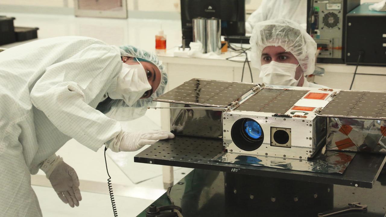 Left to right: Electrical Test Engineer Esha Murty and Integration and Test Lead Cody Colley prepare the ASTERIA spacecraft for mass-properties measurements in April 2017 prior to spacecraft delivery ahead of launch. ASTERIA was deployed from the International Space Station in November 2017.  https://photojournal.jpl.nasa.gov/catalog/PIA23406