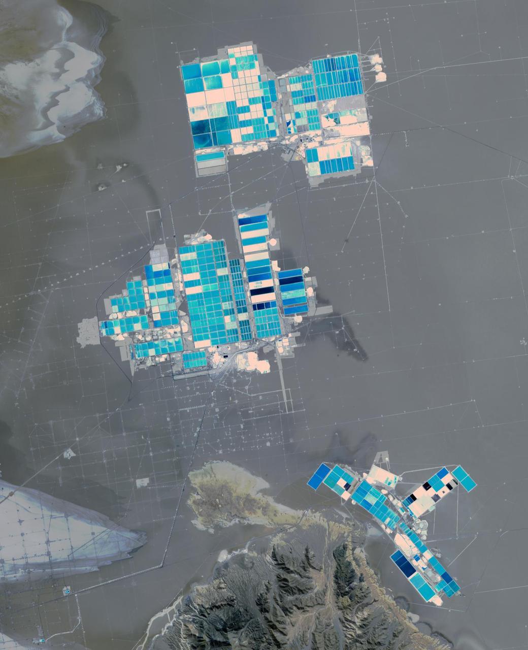 Salar de Atacama (Atacama salt flats) in Chile's Atacama Desert receives 2 mm rain per year. Its attraction are the brines 40 m below ground. They are pumped to the surface into large evaporation pans. After the water has vanished, a yellowish greasy solution is left behind that contains lithium. In fact, Salar de Atacama produces 27% of the world's annual supply. Mining lithium here is less expensive to produce than from neighboring Salar de Uyuni, which is estimated to have half of the lithium reserves in the world. The image was acquired August 21, 2017, covers an area of 22.5 by 27.8 km, and is located at 23.5 degrees south, 68.3 degrees west.  https://photojournal.jpl.nasa.gov/catalog/PIA23420