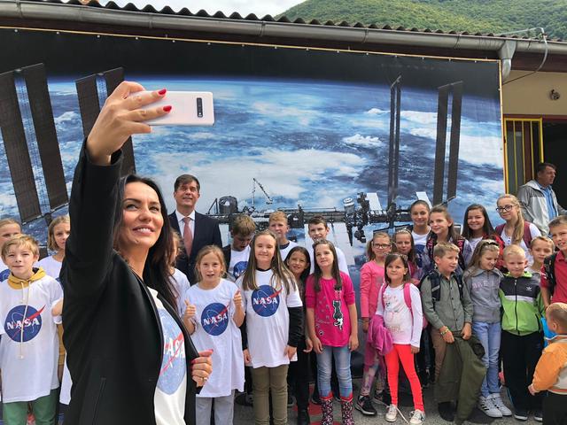 On Sept. 23, 2019, Eric Nelson, the U.S. Ambassador to Bosnia and Herzegovina, presented a framed letter to Snezana Ružičić, mayor of the Balkan municipality of Jezero. The letter, from NASA's director of Mars Exploration, James Watzin, honored the connection between the small Balkan town and Jezero Crater the landing site of NASA's upcoming Mars 2020 mission. In this picture, Ružičić snaps a selfie of the ambassador with local school children.  https://photojournal.jpl.nasa.gov/catalog/PIA23463