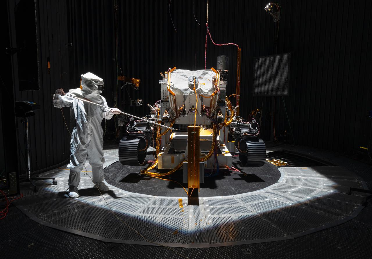 An engineer working on NASA's Mars 2020 mission uses a solar intensity probe to measure and compare the amount of artificial sunlight that reaches different portions of the rover. To simulate the Sun's rays for the test, powerful xenon lamps several floors below the chamber were illuminated, their light directed onto a mirror at the top of the chamber and reflected down on the spacecraft. The data collected during this test will be used to confirm thermal models the team has generated regarding how the Sun's rays will interact with the 2020 rover while on the surface of Mars.  The image was taken on Oct. 14, 2019, in the Space Simulator Facility at NASA's Jet Propulsion Laboratory in Pasadena, California.  https://photojournal.jpl.nasa.gov/catalog/PIA23469