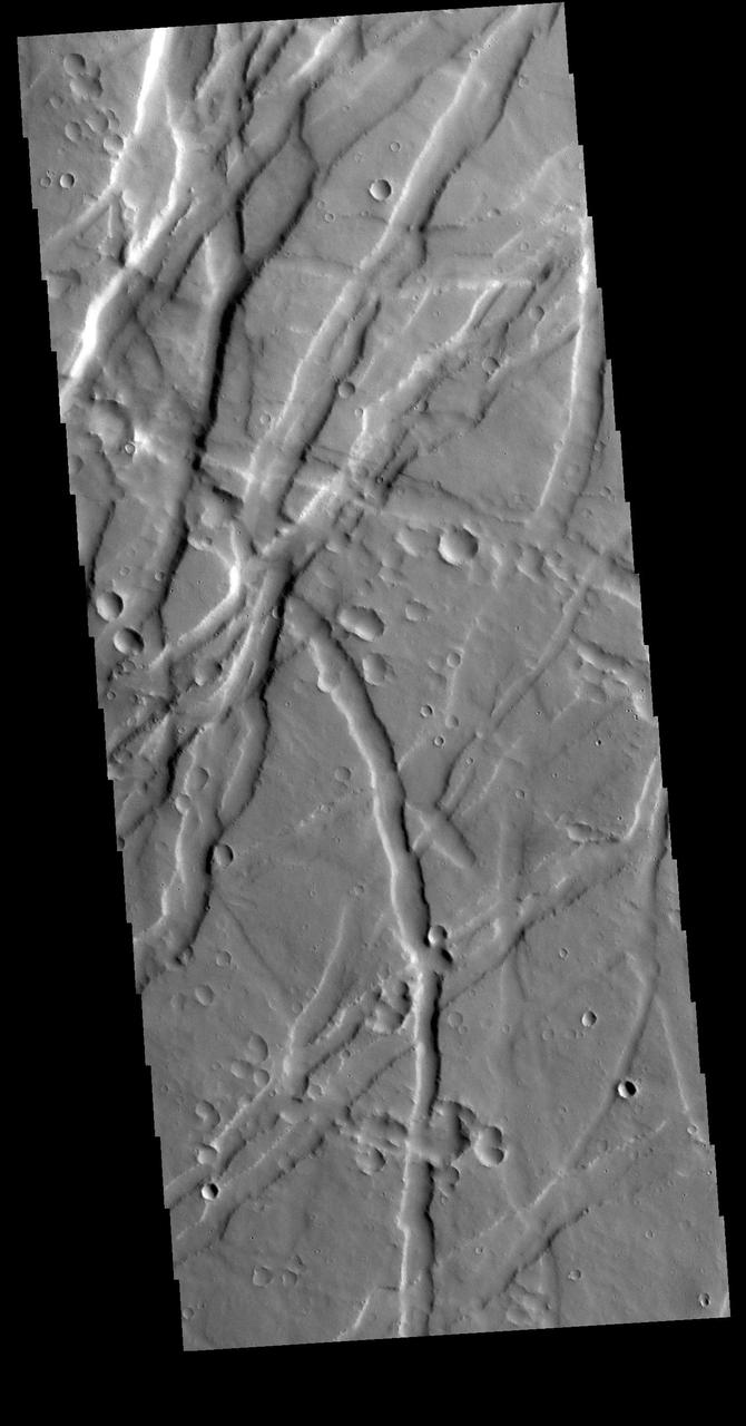 Uranius Fossae is region of multi directional graben. Graben are tectonic features created by extension, where blocks of material move downward between paired faults. This region of graben is located east of Uranius Mons. Orbit Number: 78842 Latitude: 23.1816 Longitude: 269.606 Instrument: VIS Captured: 2019-09-23 04:08 https://photojournal.jpl.nasa.gov/catalog/PIA23505