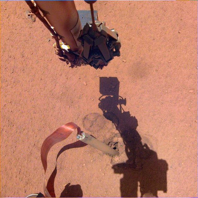 The shadow of NASA InSight's robotic arm moves over its heat probe, or "mole," on Nov. 3, 2019, the 333rd Martian day, or sol, of the mission.  Animation available at https://photojournal.jpl.nasa.gov/catalog/PIA23512