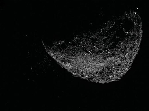 This view of asteroid Bennu ejecting particles from its surface on Jan. 6, 2019, was created by combining two images taken by the NavCam 1 imager aboard NASA's OSIRIS-REx spacecraft.