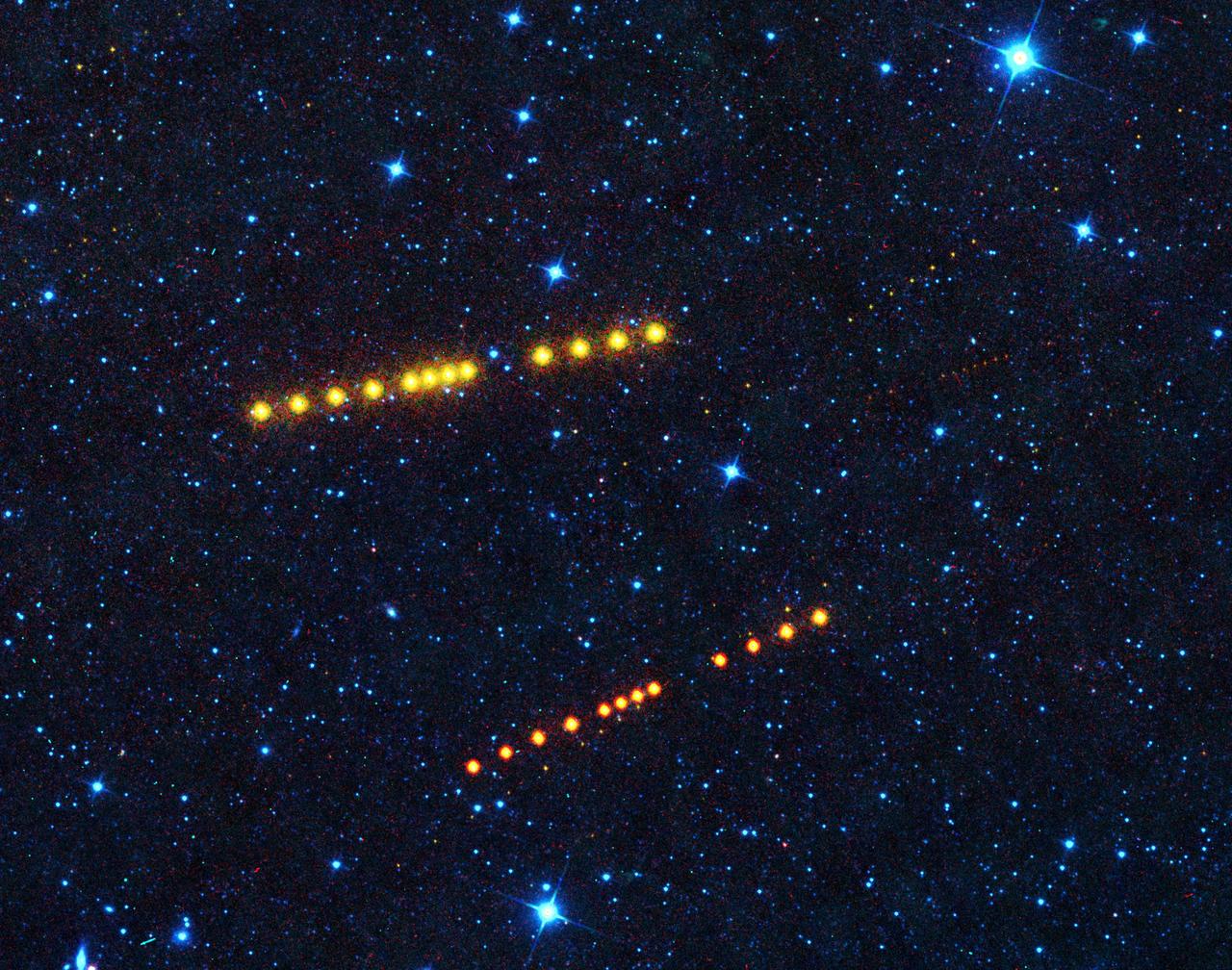 Those aren't Klingon vessels. Appearing as strings of orange dots, the brightest sets of dots belong to asteroids Klotho and Lina. Both orbit out in the main asteroid belt between Mars and Jupiter, while smaller, more distant asteroids can also be seen passing through the image.  https://photojournal.jpl.nasa.gov/catalog/PIA23589