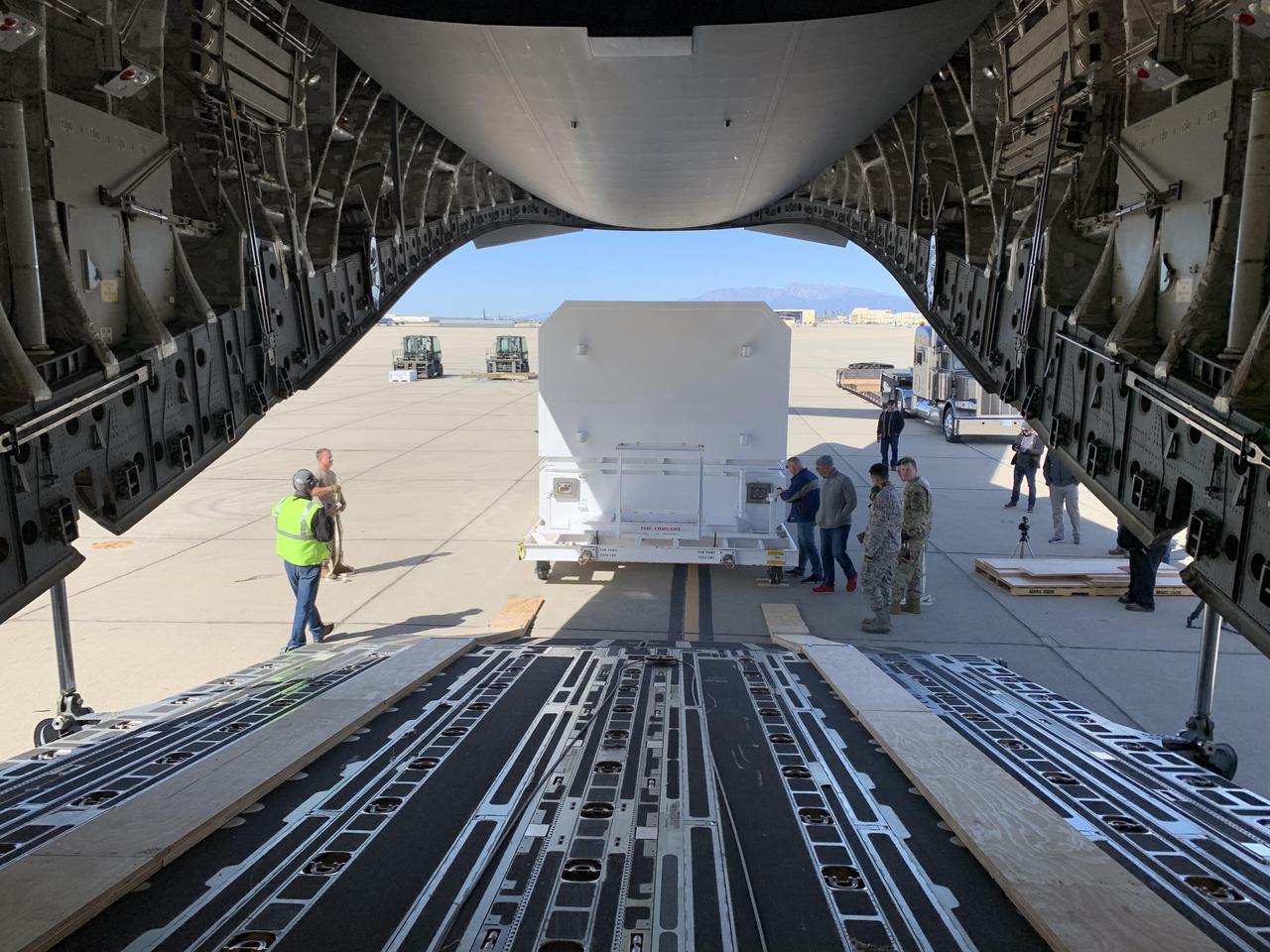 The shipping container carrying NASA's Mars 2020 rover is readied for loading aboard an Air Force C-17 transport plane at March Air Reserve Base in Riverside, California, on Feb. 11, 2020.  https://photojournal.jpl.nasa.gov/catalog/PIA23592