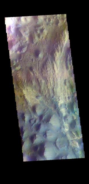 This false color image shows part of Juventae Chasma. Located north of Valles Marineris, Juventae Chasma stretches for 180 kilometers (110 miles) east-west and 250 km (155 mi) north-south. Most of its floor lies 5,000 meters (16,000 feet) or more below the surrounding surface. Juventae Chasma is the source region for the outflow channel Maja Valles. The THEMIS VIS camera contains 5 filters. The data from different filters can be combined in multiple ways to create a false color image. These false color images may reveal subtle variations of the surface not easily identified in a single band image. Orbit Number: 65981 Latitude: -2.2663 Longitude: 298.189 Instrument: VIS Captured: 2016-10-28 18:05 https://photojournal.jpl.nasa.gov/catalog/PIA23627