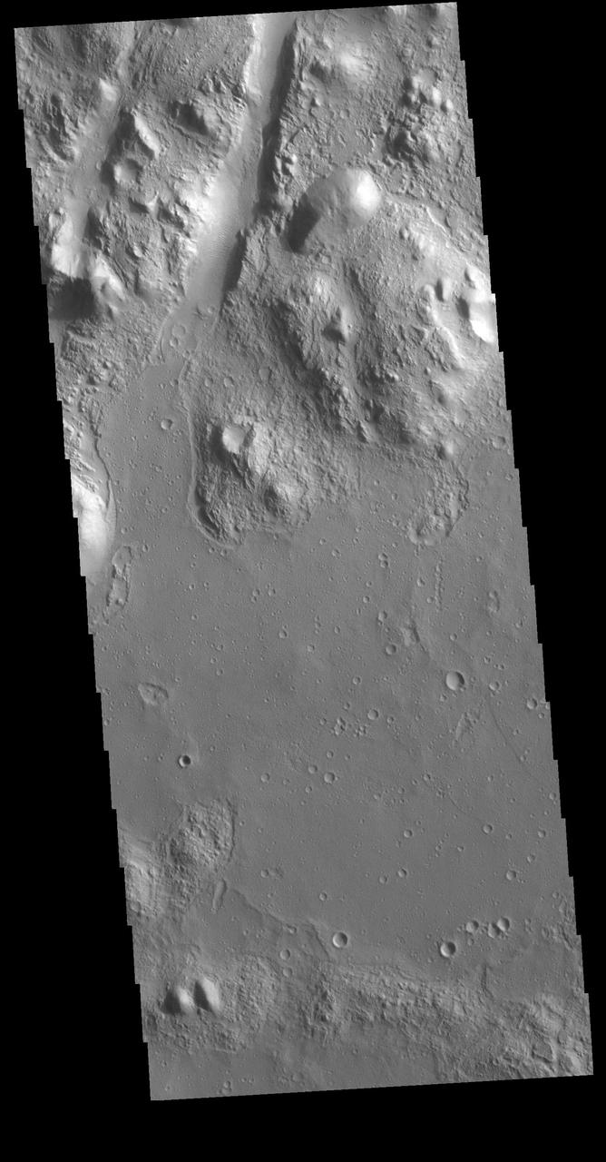 At the upper part of this VIS image is one of the graben that comprise Amenthes Fossae. Graben are formed when a block of material drops downward between paired tectonic faults. Amenthes Fossae are located on both sides of Amenthes Planum. Orbit Number: 79085 Latitude: 9.14503 Longitude: 100.803 Instrument: VIS Captured: 2019-10-13 04:17 https://photojournal.jpl.nasa.gov/catalog/PIA23638