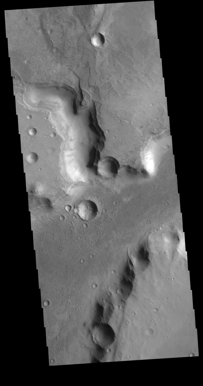 The channels in this VIS image are part of Nili Fossae. Nili Fossae is a collection of curved faults and down-dropped blocks of crust between the faults (called graben). The graben lie northeast of the large volcano Syrtis Major and northwest of the ancient impact basin Isidis Planitia. The graben make concentric curves that follow the outline of Isidis Planitia; the faults likely formed as the crust sagged under the weight of lava flows filling the Isidis basin. Orbit Number: 79485 Latitude: 25.7316 Longitude: 78.4041 Instrument: VIS Captured: 2019-11-15 02:51 https://photojournal.jpl.nasa.gov/catalog/PIA23662