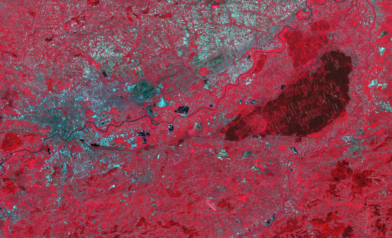 The Niepolmice Forest in Poland consists of six nature reserves, providing sanctuary for such threatened animals as lynx, wild cats and European Bison. Because of its proximity to Krakow, the old capital of Poland (left side of image), the forest (right side of image, dark red area) was a hunting ground for Polish Royalty beginning in the 13th century. The image was acquired May 25, 2003, covers an area of 29.5 by 48.5 km, and is located at 50 degrees north, 20.4 degrees east. With its 14 spectral bands from the visible to the thermal infrared wavelength region and its high spatial resolution of about 50 to 300 feet (15 to 90 meters), ASTER images Earth to map and monitor the changing surface of our planet. ASTER is one of five Earth-observing instruments launched Dec. 18, 1999, on Terra. The instrument was built by Japan's Ministry of Economy, Trade and Industry. A joint U.S./Japan science team is responsible for validation and calibration of the instrument and data products. The broad spectral coverage and high spectral resolution of ASTER provides scientists in numerous disciplines with critical information for surface mapping and monitoring of dynamic conditions and temporal change. Example applications are monitoring glacial advances and retreats; monitoring potentially active volcanoes; identifying crop stress; determining cloud morphology and physical properties; wetlands evaluation; thermal pollution monitoring; coral reef degradation; surface temperature mapping of soils and geology; and measuring surface heat balance. https://photojournal.jpl.nasa.gov/catalog/PIA23678