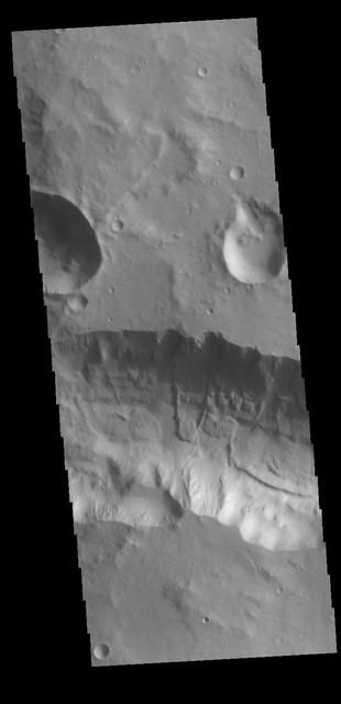 This VIS image shows a section of the tributary channel between Aram Chaos and Ares Vallis. A small landslide deposit is visible in the middle of the image. Orbit Number: 79763 Latitude: 2.95902 Longitude: 341.373 Instrument: VIS Captured: 2019-12-08 00:06 https://photojournal.jpl.nasa.gov/catalog/PIA23710