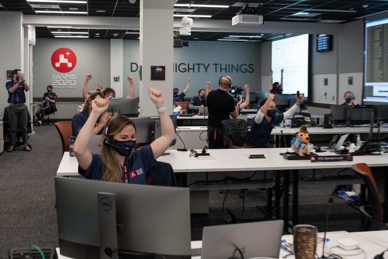 Inside a mission support area at NASA's Jet Propulsion Laboratory in Southern California, Mars 2020 Perseverance team members displayed their joy as the spacecraft successfully completed a complex series of steps to safely touch down on the Martian surface. JPL built and manages operations of the Mars 2020 Perseverance rover for NASA.  A key objective for Perseverance's mission on Mars is astrobiology, including the search for signs of ancient microbial life. The rover will characterize the planet's geology and past climate, pave the way for human exploration of the Red Planet, and be the first mission to collect and cache Martian rock and regolith (broken rock and dust).  Subsequent NASA missions, in cooperation with ESA (European Space Agency), would send spacecraft to Mars to collect these sealed samples from the surface and return them to Earth for in-depth analysis.  The Mars 2020 mission is part of a larger program that includes missions to the Moon as a way to prepare for human exploration of the Red Planet.  https://photojournal.jpl.nasa.gov/catalog/PIA23723