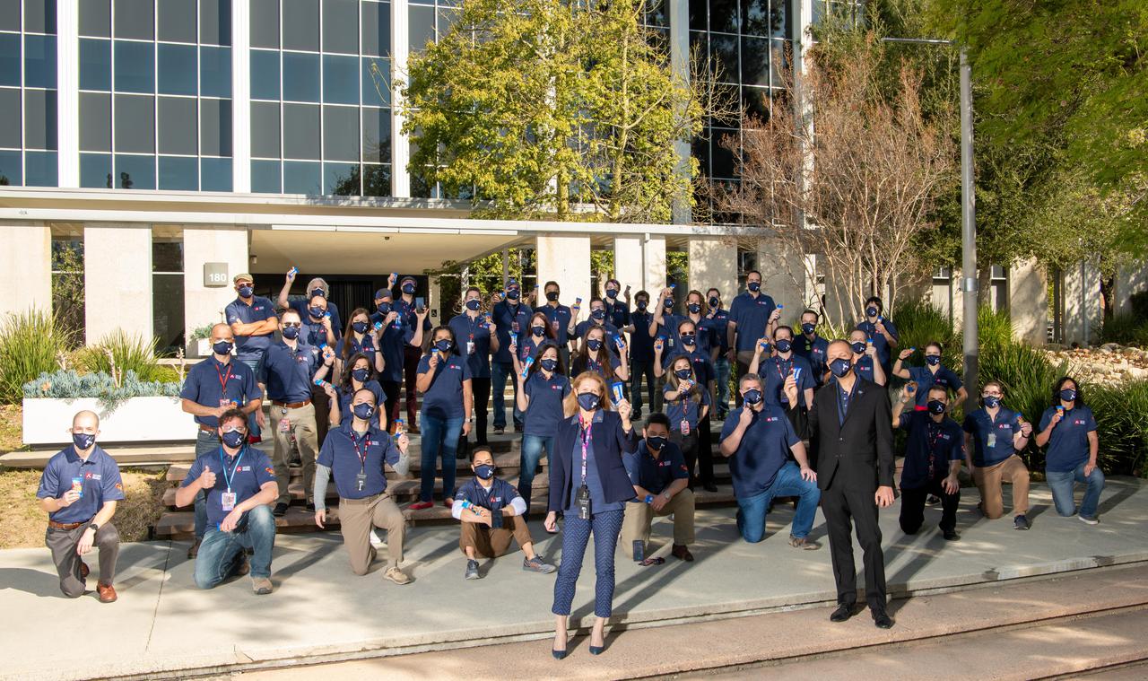 Before NASA's Mars Perseverance rover landed on Mars on Feb. 18, 2021, the entry, descent, and landing team posed at the agency's Jet Propulsion Laboratory in Southern California with individual bags of traditional "lucky peanuts." Eating peanuts before major mission events is a longstanding tradition at JPL. In the foreground are (left to right) NASA Planetary Science Division Director Lori Glaze and NASA Science Mission Directorate Associate Administrator Thomas Zurbuchen.  A key objective for Perseverance's mission on Mars is astrobiology, including the search for signs of ancient microbial life. The rover will characterize the planet's geology and past climate, pave the way for human exploration of the Red Planet, and be the first mission to collect and cache Martian rock and regolith (broken rock and dust).  Subsequent NASA missions, in cooperation with ESA (European Space Agency), would send spacecraft to Mars to collect these sealed samples from the surface and return them to Earth for in-depth analysis.  The Mars 2020 mission is part of a larger program that includes missions to the Moon as a way to prepare for human exploration of the Red Planet.  https://photojournal.jpl.nasa.gov/catalog/PIA23724