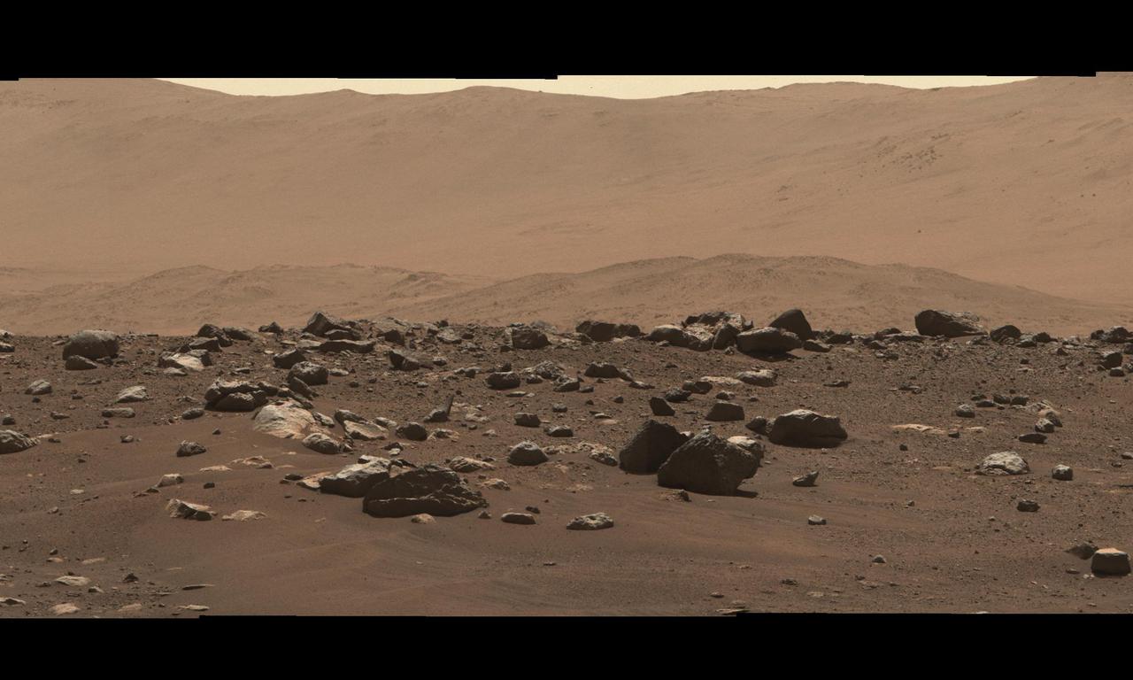 Stitched together from 79 individual images, this Mastcam-Z right-eye 110-mm zoom mosaic is from the camera's first high-resolution panorama imaging sequence. These images were taken on the afternoon of Sol 4 (Feb. 22, 2021) of the mission; a sol is a Martian day.  The camera was commanded to take these images by scanning the mast, or "head," a full 360-degrees around the horizon visible from the landing site. The top of some of the distant crater rim is cut off in some images to ensure the images would cover the front ridge of the Jezero Crater's ancient delta, which is only about 1.25 miles (2 kilometers) away from the rover in the center of this panorama. At that distance and focal length, Mastcam-Z can resolve features as small as about 50 centimeters (1.6 feet) across along the front of the delta.  The mosaic is not white balanced but is instead displayed in a preliminary calibrated version of a natural color composite, approximately simulating the colors of the scene that we would see if we were there viewing it ourselves.  Arizona State University in Tempe leads the operations of the Mastcam-Z instrument, working in collaboration with Malin Space Science Systems in San Diego.  A key objective for Perseverance's mission on Mars is astrobiology, including the search for signs of ancient microbial life. The rover will characterize the planet's geology and past climate, pave the way for human exploration of the Red Planet, and be the first mission to collect and cache Martian rock and regolith (broken rock and dust).  Subsequent NASA missions, in cooperation with ESA (European Space Agency), would send spacecraft to Mars to collect these sealed samples from the surface and return them to Earth for in-depth analysis.  The Mars 2020 Perseverance mission is part of NASA's Moon to Mars exploration approach, which includes Artemis missions to the Moon that will help prepare for human exploration of the Red Planet.  Complete mosaic available at https://photojournal.jpl.nasa.gov/catalog/PIA23727