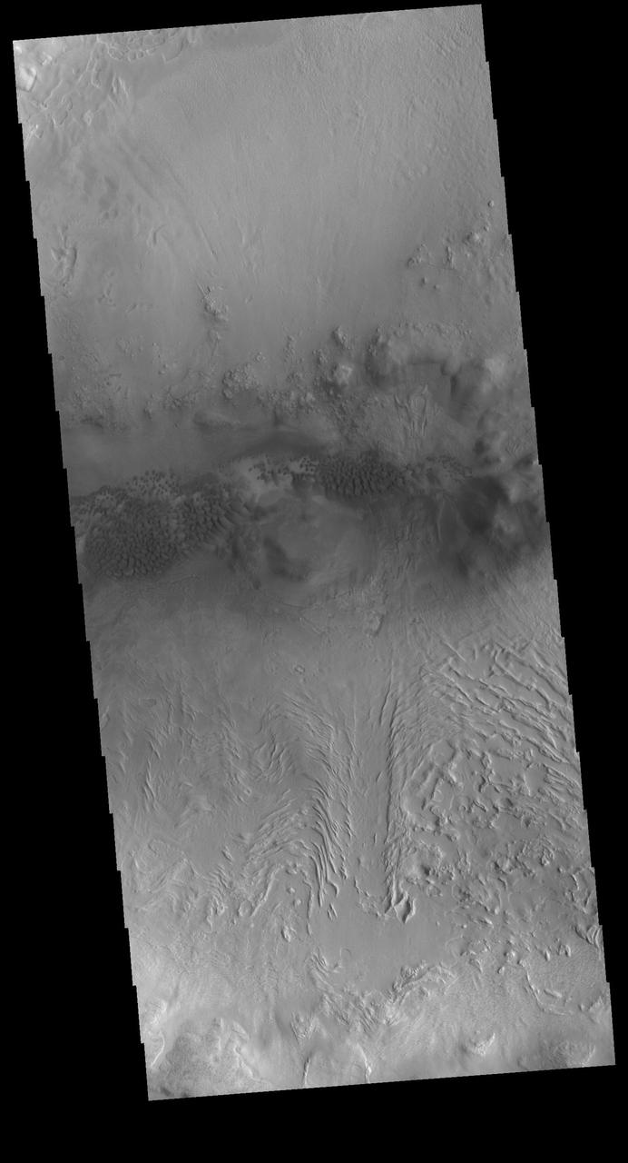 This VIS image shows sand dunes on the floor of an unnamed crater located between Terra Sabaea and Utopia Planitia. The inner crater rim seen in the bottom half of the image has flow-like features. This morphology is usually indicative of material containing a volatile such as ice moving downslope. Orbit Number: 79947 Latitude: 42.4781 Longitude: 67.2101 Instrument: VIS Captured: 2019-12-23 03:56 https://photojournal.jpl.nasa.gov/catalog/PIA23744