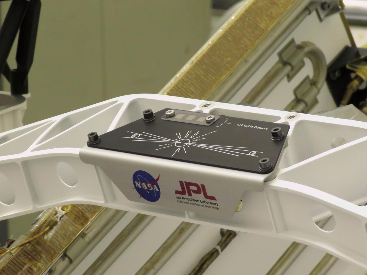 A placard commemorating NASA's "Send Your Name to Mars" campaign was installed on the Perseverance Mars rover on March 16, 2020, at NASA's Kennedy Space Center in Florida. Three fingernail-sized chips affixed to the upper-left corner of the placard feature the names of 10,932,295 people who participated. They were individually stenciled onto the chips by electron beam, along with the essays of the 155 finalists in NASA's "Name the Rover" contest. Liftoff aboard a United Launch Alliance Atlas V 541 rocket is targeted for mid-July of 2020 from Cape Canaveral Air Force Station. NASA's Launch Services Program, based at Kennedy, is managing the launch.  https://photojournal.jpl.nasa.gov/catalog/PIA23769
