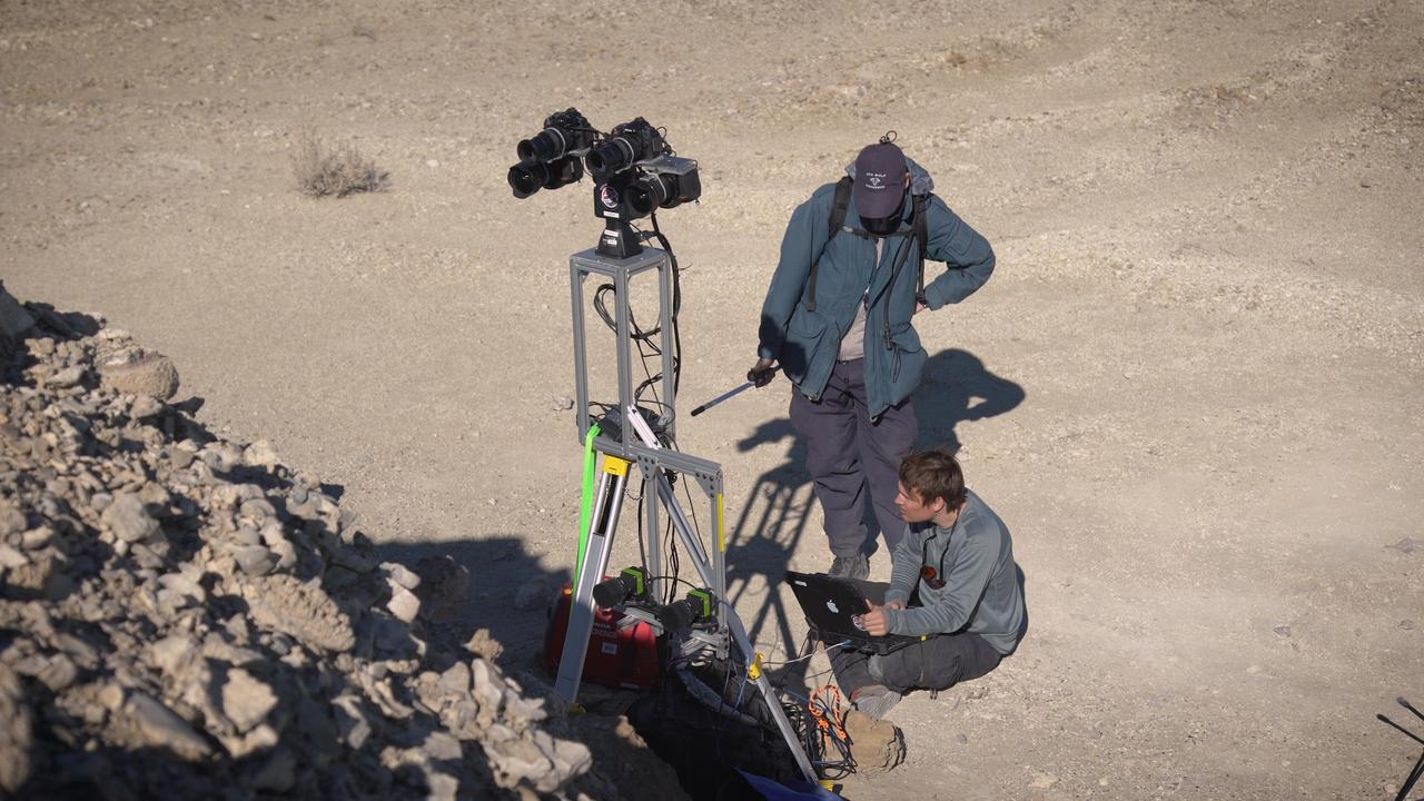 Two members of a field team set up cameras in the Nevada desert in February 2020, as part of a simulated rover operation designed to train scientists who will work with NASA's Perseverance rover after it lands on Mars in February 2021. https://photojournal.jpl.nasa.gov/catalog/PIA23777