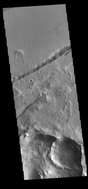 This VIS image shows a section of Sirenum Fossae. The linear depression was created by tectonic forces stretching the surface. Paired faults allow blocks of the surface to slide down into the open space. The linear depression is called a graben. Orbit Number: 80616 Latitude: -27.3687 Longitude: 217.266 Instrument: VIS Captured: 2020-02-16 05:35 https://photojournal.jpl.nasa.gov/catalog/PIA23856