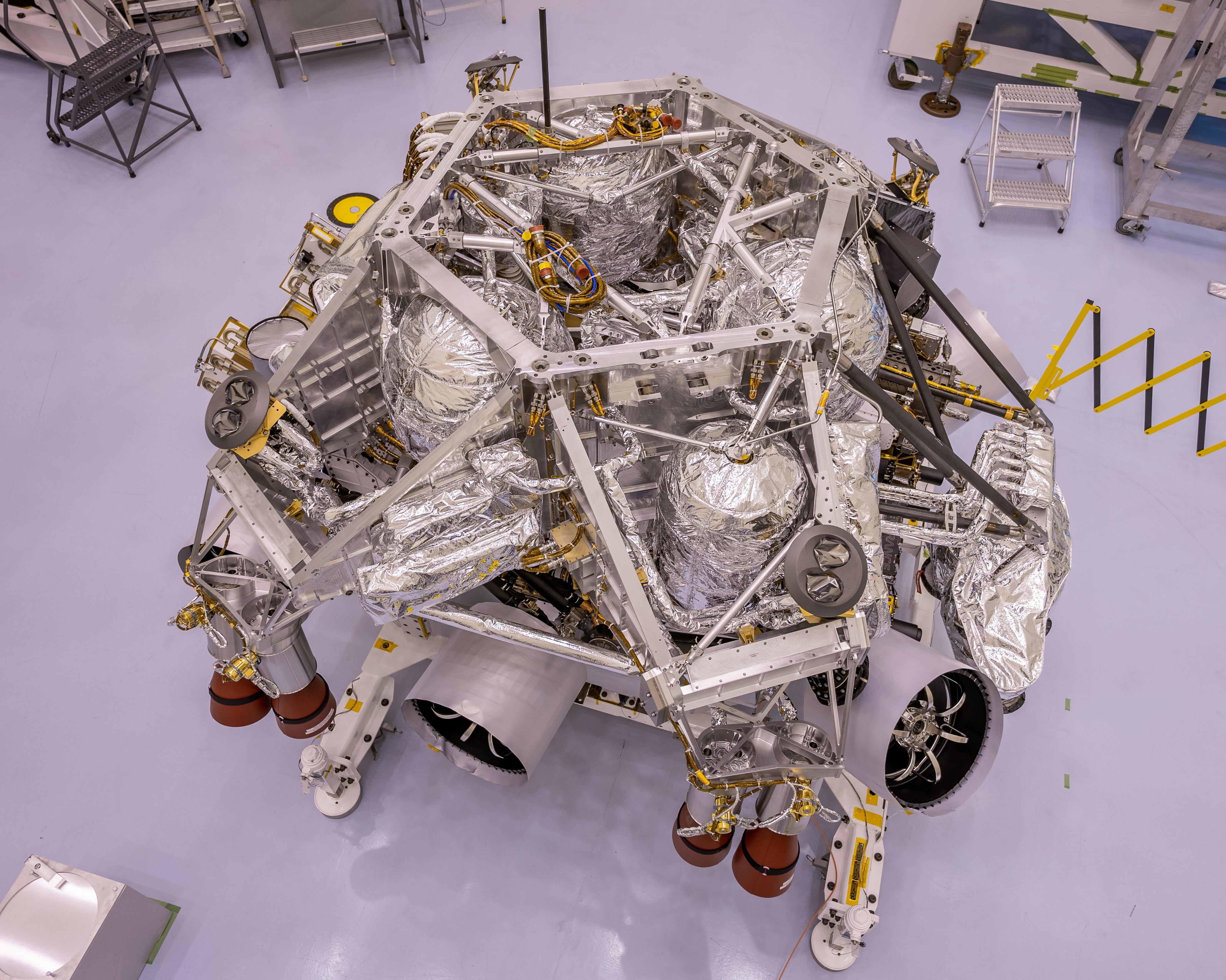 This image of the rocket-powered descent stage sitting on top of NASA's Perseverance rover was taken in a clean room at Kennedy Space Center on April 29, 2020. The integration of the two spacecraft was the first step in stacking the mission's major components into the configuration they will be in while sitting atop of the Atlas V rocket.  https://photojournal.jpl.nasa.gov/catalog/PIA23886