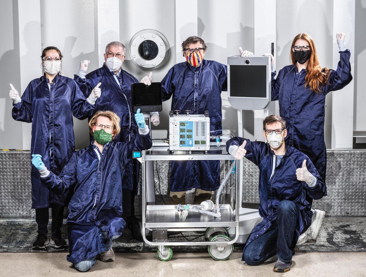 Some of the dozens of engineers involved in creating a ventilator prototype specially targeted to coronavirus disease patients at NASA's Jet Propulsion Laboratory in Southern California. Called VITAL (Ventilator Intervention Technology Accessible Locally), the prototype was created in 37 days in March and April 2020.  Left to right, standing: Shaunessy Grant, Michael Johnson, Dave Van Buren, Michelle Easter.  Left to right, kneeling: Brandon Metz, Patrick Degrosse.  https://photojournal.jpl.nasa.gov/catalog/PIA23891